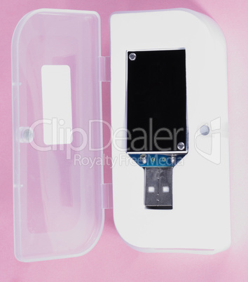 electronic device in plastic case on pink background at day