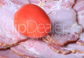 one tomato on ham meat