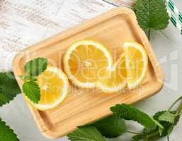 sliced yellow juicy lemon slices  and green fresh mint leaves