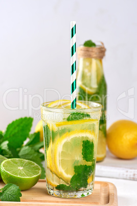 cold drink of fresh lemons, lime, mint green and pieces of ice i