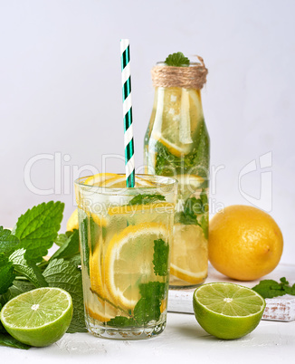 cold drink of fresh lemons, lime, mint green and pieces of ice i