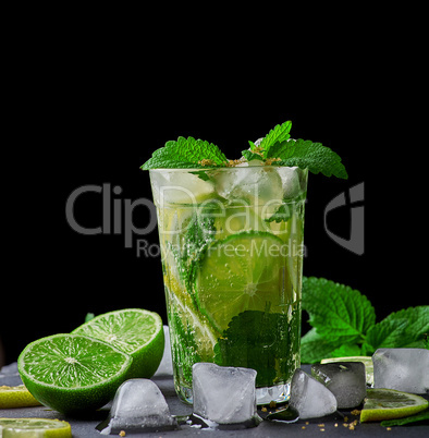 cold drink of fresh lemons, lime, mint green and ice cubes in a