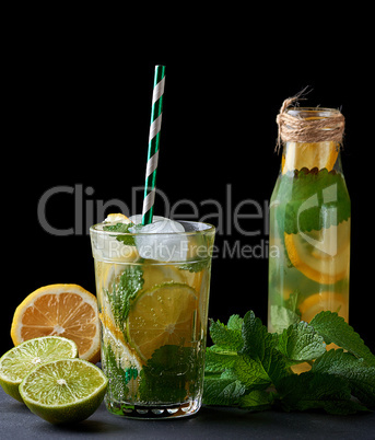 cold lemonade from fresh lemons, lime and mint green in a glass