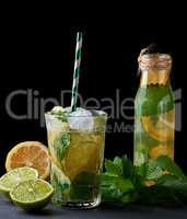 cold lemonade from fresh lemons, lime and mint green in a glass