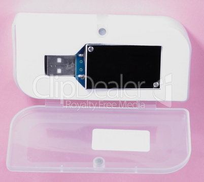 electronic device in plastic case on pink background at day