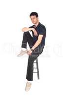 Handsome tall young man sitting on chair