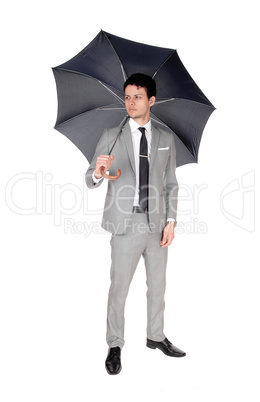 A young  man standing with an open umbrella