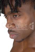 A close up portrait of the face of a black man without an shirt