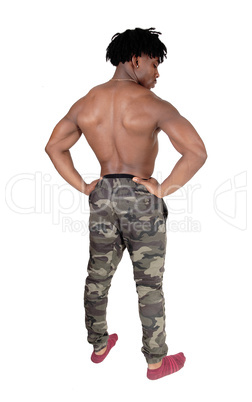Muscular black man standing shirtless from the back