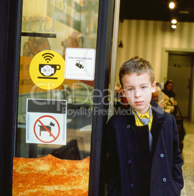 Schoolchild at the cafe doorway