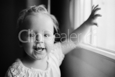 Portrait of happy one year old girl in black and white