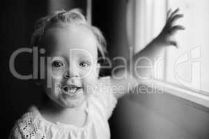 Portrait of happy one year old girl in black and white