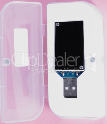 electronic device in plastic case on pink background at day