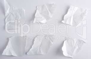 crumpled empty torn pieces of white paper
