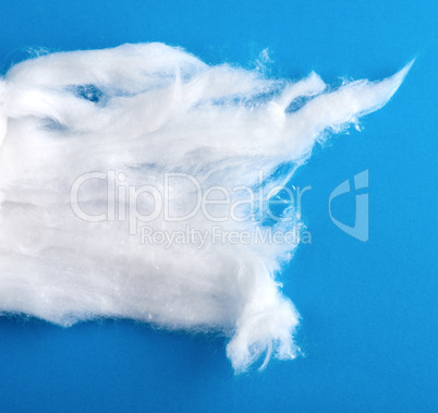 white wool with torn edges on a blue background