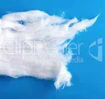 white wool with torn edges on a blue background