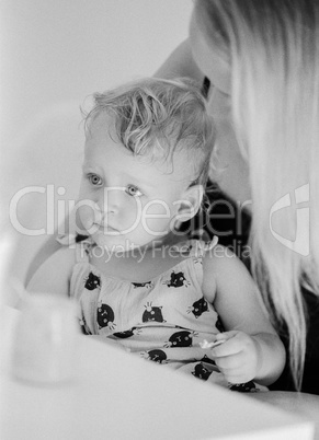 Black and white portrait of baby girl with mum at home