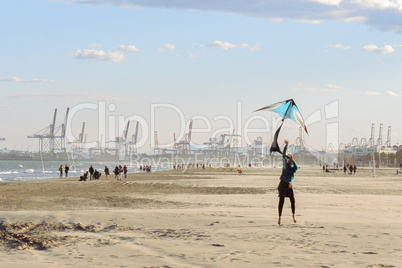 Flying a kite on winter beach