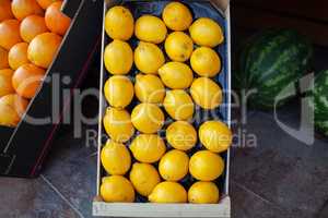 A closeup of bright lemons in a box