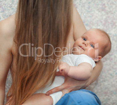 Baby in hands of loving and caring mother