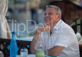 Charming mature man in outdoor cafe