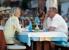 Loving mature couple having dinner in outdoor cafe