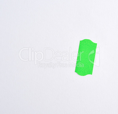 empty white sheet of paper and green paper sticky tape to write