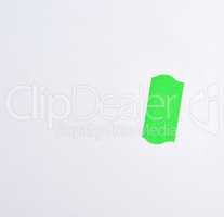 empty white sheet of paper and green paper sticky tape to write