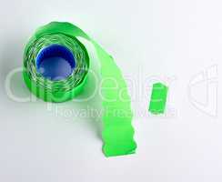 coil with green empty sticky price tags on white background