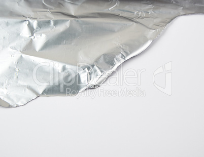 ragged edge of silver foil ra white backgroun