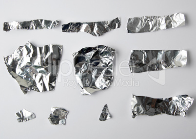 various pieces of foil on a white background