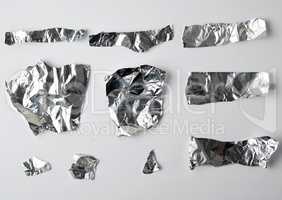 various pieces of foil on a white background