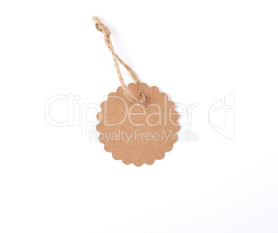 empty paper round brown tag on a rope, white background