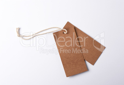 empty paper brown tag on the rope, white background