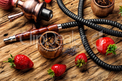 Smoking hookah on strawberry