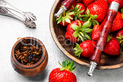 Smoking hookah on strawberry