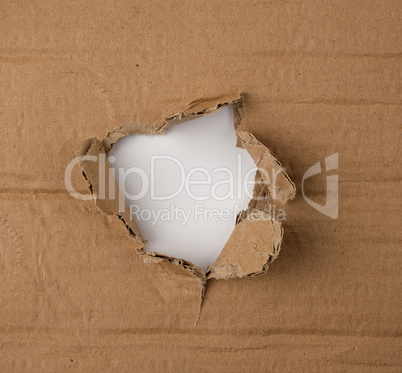 brown sheet of paper with a hole, full frame
