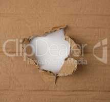 brown sheet of paper with a hole, full frame