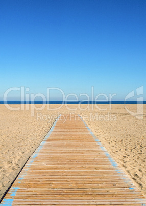 Empty beach and wooden path