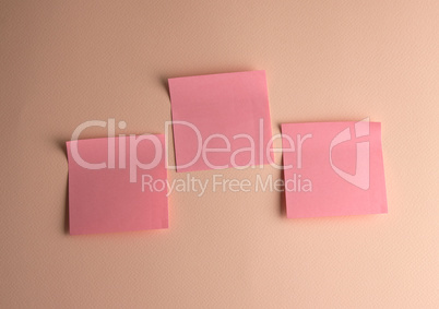 three pink paper stickers pasted on white background