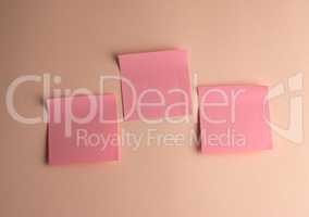three pink paper stickers pasted on white background