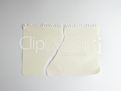 sheet of white paper torn in half with a spiral notepad