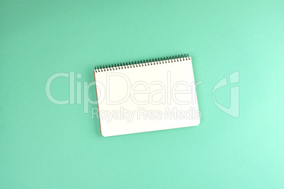 open spiral notebook with clean white sheets