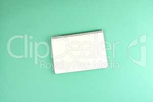 open spiral notebook with clean white sheets