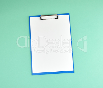 blue holder with clean white sheets on a green background
