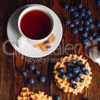 Cup of Tea with Blueberries and Belgian Waffles.