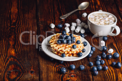 Waffles with Blueberry and Hot Chocolate.