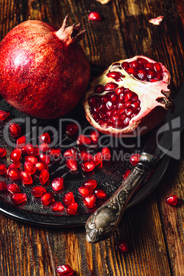 Pomegranates with Seeds and Knife.