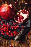 Pomegranates with Seeds and Knife.