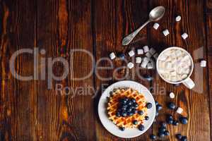 Waffles with Blueberry and Hot Chocolate.